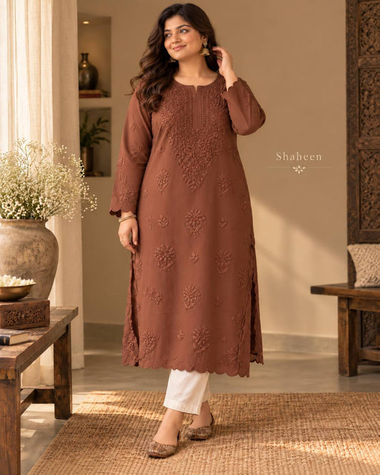 Model wearing the mocha brown Shahin Chikankari kurta with scalloped cutwork hem, standing in a studio.
