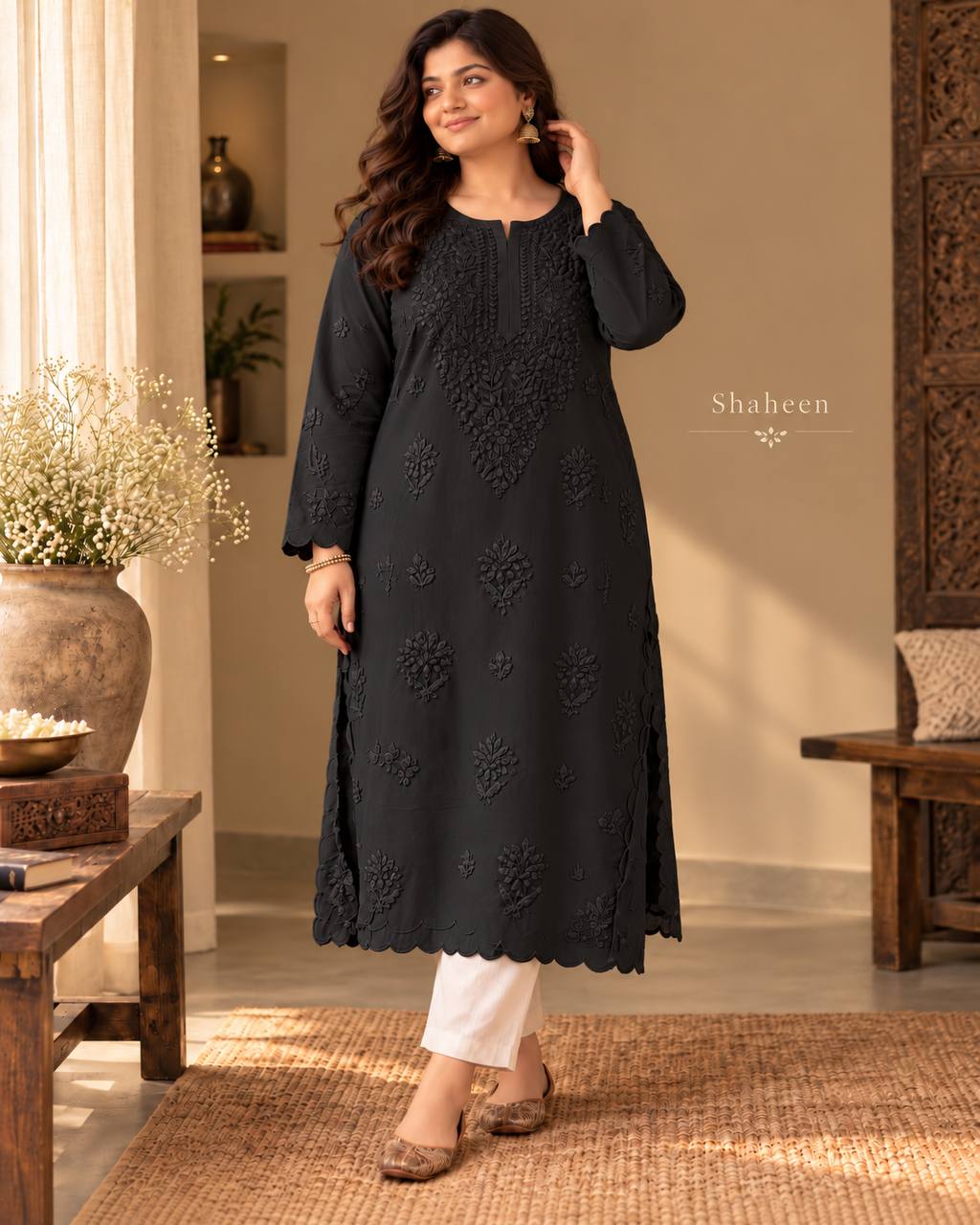 Model wearing the black Shahin Chikankari kurta with tonal embroidery and scalloped hem, standing in a studio.